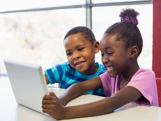 School kids using a digital tablet in classroom
