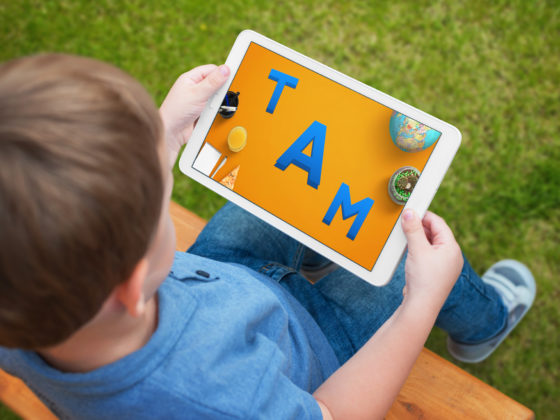 A child using an educational app on his iPad.