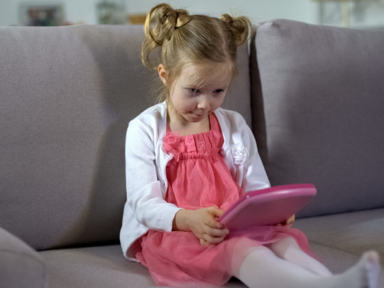 Little girl playing with a learning app.
