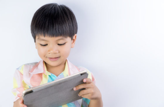 Kid reading on tablet