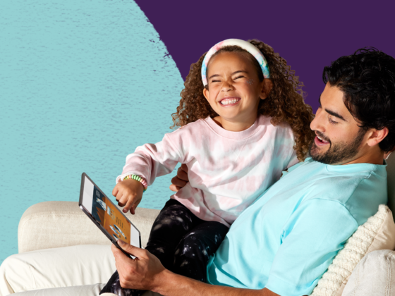 Smiling child listening to audiobooks and reading graphic novels, perfect for reluctant readers