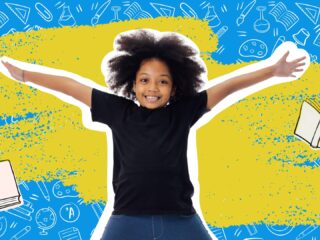 Smiling child with arms outstretched in front of a blue background covered in school supply doodles