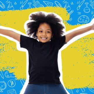 Smiling child with arms outstretched in front of a blue background covered in school supply doodles